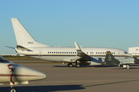 165833 @ AFW - At Alliance - Fort Worth - Parked in a ramp full of stuff! - US Navy C-40A Clipper