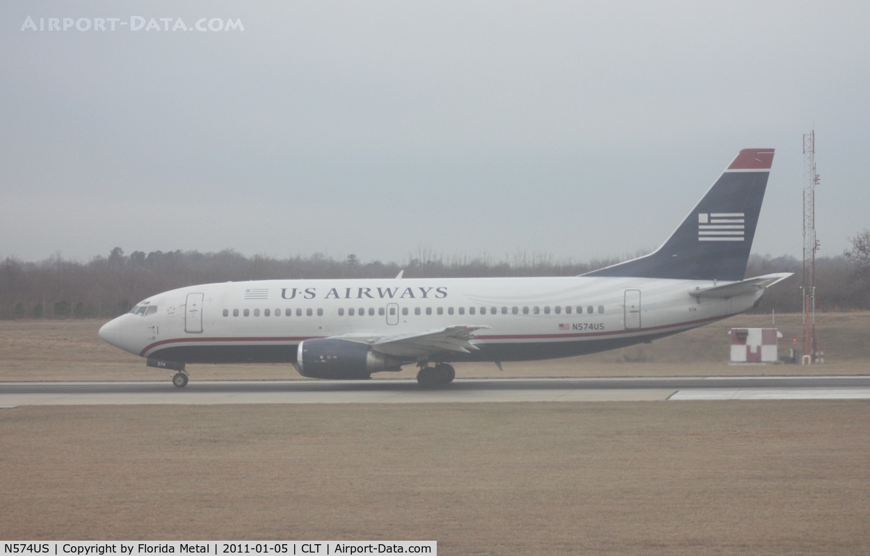 N574US, 1987 Boeing 737-301 C/N 23739, US Airways 737-300 departing at CLT - taken out of the hazy window of my US Airways A319