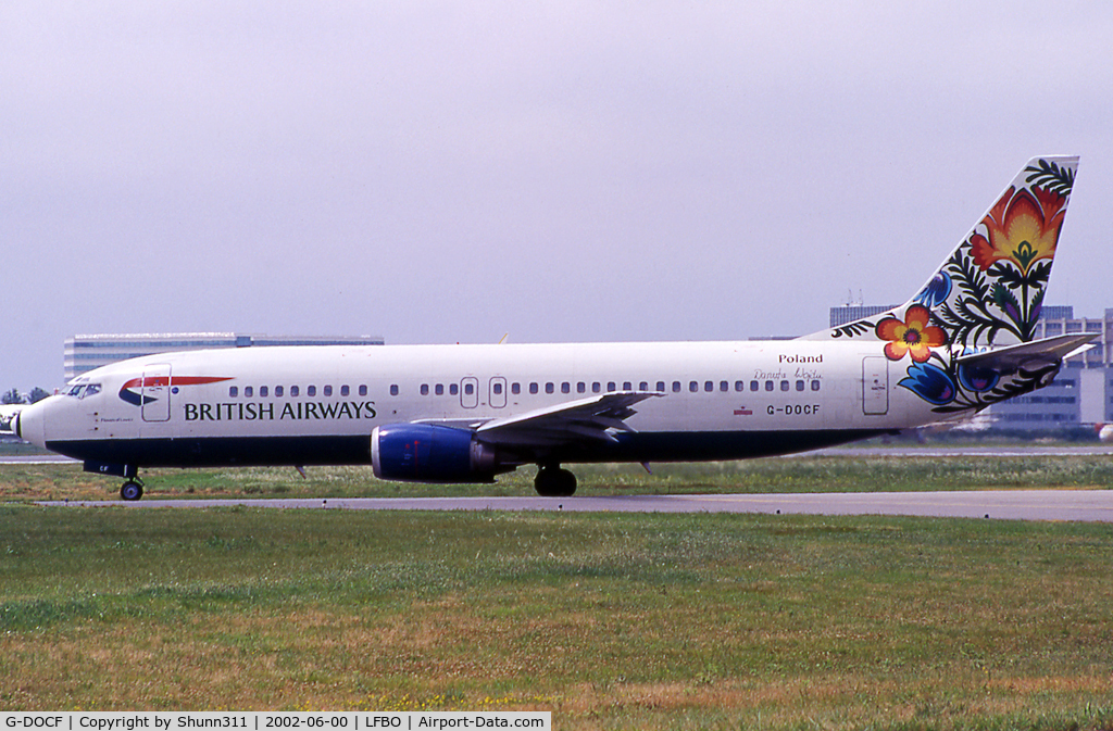 G-DOCF, 1991 Boeing 737-436 C/N 25407, Taxiing holding point rwy 32R for departure in 'Cockerel of Lowicz' tail c/s