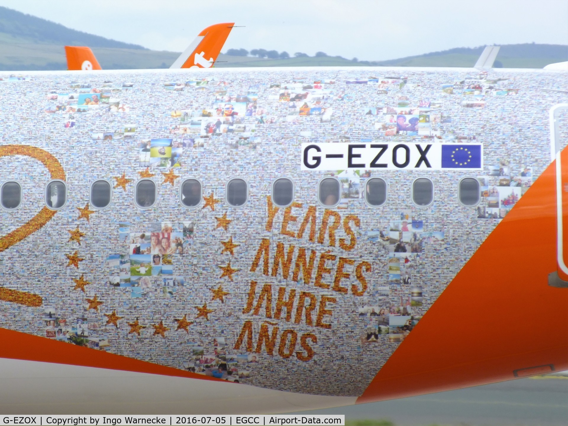 G-EZOX, 2015 Airbus A320-214 C/N 6837, Airbus A320-214 of easyJet in special '20 years jubilee' colours at Manchester airport. The background seems to be composed of thousands of holiday fotos.