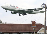 EP-IAM @ LHR - Iranair Boeing 747-100 (EP-IAM) flies across the roofs of Myrtle Avenue, on the approach to London (Heathrow) Airport in May 2004 - by Adrian Pingstone