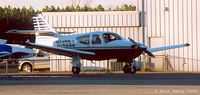 N1409J @ PVG - Tucked away between hangars as the sun sets - by Paul Perry