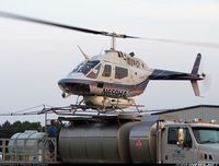 N659HA - N659HA (cn 70-15159) This Bell chopper is one of 13 used by a Gettysburg, PA company as aerial applicators. The pilot is seen here concentrating on hitting his mark, which happens to be a helipad attached to the top of a tanker truck. The truck is equippe - by Travis Faudree