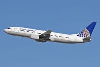 N13248 @ LAX - Departing RWY 25R on a clear November day. - by Dean Heald