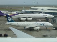 ZK-OJN @ AKL - Air New Zealand's A320 looks dwarfed between the B777-200 and the A340-600... - by Micha Lueck