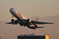 N584FE @ LAX - FedEX N584FE departing LAX RWY 25L on an early morning in November.