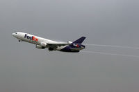 N68052 @ LAX - FedEx N68052 (FLT FDX3603) departing LAX RWY 25R on a very overcast morning enroute to Indianapolis, Indiana (KIND).