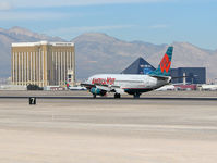 N313AW @ KLAS - America West Airlines / 1987 Boeing 737-3S3 / I swear...Mandalay Bay is crooked...the foundation that is! Really, it is!