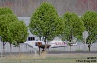 N2582C @ PVG - On the roadway between hangars, and partially obscured by the flora - by Paul Perry