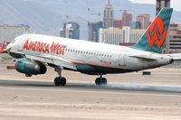 N827AW @ LAS - America West N827SW touching down on RWY 25L. - by Dean Heald