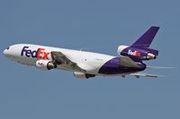 N556FE @ LAX - FedEx N556FE (MD-10-10F) - FLT FDX3019 - climbing out from RWY 25R enroute to Chicago Ohare Int'l (KORD), Illinois. Note the condensation trails from the wingtips and condensation over the wings.