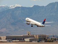 N187DN @ KLAS - Delta Airlines against the background of the Spring Mountains and Mt. Charleston - by SkyNevada - Brad Campbell