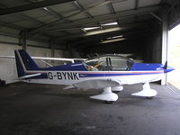 G-BYNK @ EGLA - Robin HR100 in the hangar at Bodmin