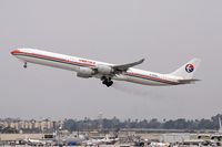 B-6050 @ LAX - China Eastern B-6050 departing RWY 25R trailing brake dust.