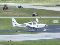 N723CD @ PDK - Doing run-up with mowers in the background - by Michael Martin