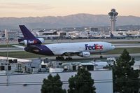 N312FE @ LAX - FedEx N312FE taxiing to the cargo terminal after arrival on RWY 25L on a clear February evening.