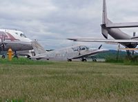 N6054W @ RDG - With a Fairchild C-119, Vickers Viscount 700, Martin 404, and other aeronautical oldies for company, this faded, forlorn 1964 Piper 140 doesn't look it will be going anywhere soon. - by Daniel L. Berek