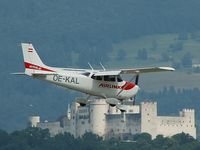 OE-KAL @ SZG - Passing by in front of the famous tower of Salzburg on final approach to Rwy 16