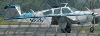N11JK @ DAN - Sorry about the fence I was doing  a drive by 1973 Beech V35B in Danville Va. - by Richard T Davis