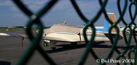 N6780U @ ECG - Well covered Mooney on the ramp