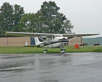 N2564U @ N85 - An immaculate 1963 Cessna Skyhawk takes in a cooling summer shower. - by Daniel L. Berek