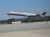 N918FJ @ MRY - America West Express CL600-2D24 getting airborne @ Monterey-Peninsula Airport, CA - by Steve Nation