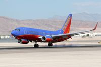 N242WN @ LAS - Southwest Airlines N242WN touching down on the right main gear first on RWY 25L.
