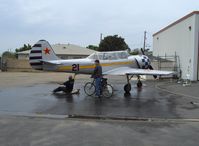 N6294D @ SZP - 1983 Yakovlev YAK 52, bath time, owner pilot under aircraft - by Doug Robertson