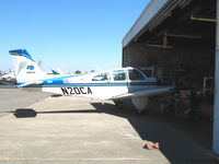 N20CA @ SAC - CALTRANS 1969 Beech E33A with her nose in the hangar @ Sacramento Executive Airport, CA - by Steve Nation