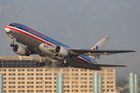 N325AA @ LAX - American Airlines N325AA (FLT AAL242) climbing out from RWY 25R enroute to John F Kennedy Int'l (KJFK). - by Dean Heald