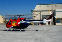 N154EH @ OAK - Red Bull 1985 MBB BO-105S photo ship for Fleet Week Red Bull air race @ Oakland International Airport, CA - by Steve Nation