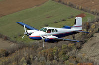 N29Y - Les Gorden's Twin Bonanza flying circles around my 150 - by Cameron Sweitzer
