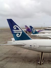 ZK-OKA @ AKL - Tails of B 777-200 (ZK-OKA), B 767-300 (ZK-NCL), and A 340-600 (HS-TNA) - by Micha Lueck
