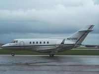 N212RG @ HOU - Taxis by the Air Terminal Museum in the rain - by Michael Bludworth