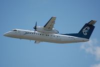 ZK-NEA @ WLG - Climbing out of Wellington - by Micha Lueck