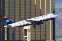 N653AW @ LAS - US Airways (America West) N653AW (FLT AWE103) climbing out from RWY 01R in front of Mandalay Bay enroute to Los Angeles Int'l (KLAX). - by Dean Heald