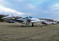 N3089L @ N75 - A 1965 Cessna 310J with engine trouble and peeling paint heads up a line of similarly afflicted aircraft at Twin Pine Airport. - by Daniel L. Berek