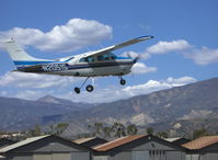 N2051S @ SZP - 1975 Cessna 210L CENTURION, Continental IO-520-L 300 Hp, takeoff climb Rwy 04 with 'Crazylegs' gear retraction. (6,704 foot Hines Peak beyond the saddle). - by Doug Robertson