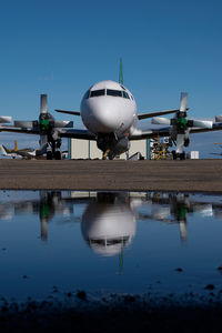 C-GZCF @ CYQF - Air Spray Lockheed Electra - reflection - by Yakfreak - VAP