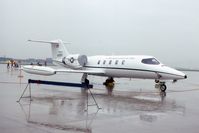 84-0087 @ ORD - C-21A during a rainy open house