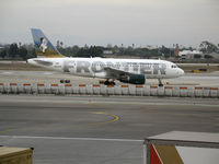 N933FR @ LAX - Frontier A319-111 with Eagle on tail turning onto active runway @ LAX - by Steve Nation