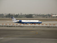 N973SW @ LAX - United Express CL-600-2B19 in new colors taxying @ LAX - by Steve Nation