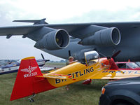 N232X @ OSH - Sharing space with a behemoth C-5A - by Jim Uber