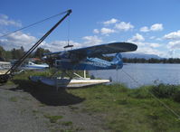 N9190D @ LHD - 1958 Piper PA-22-160 TRIPACER, Lycoming O-320-B 160 hp, engine maintenance, counterweighted boom truck with sling shows alternate method of lifting a straight-float plane out of water - by Doug Robertson