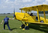 G-AHUF @ EGNW - The traditional way of starting an aircraft is demonstrated with this Tiger Moth. A hardly seen procedure nowadays. - by Joop de Groot