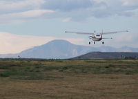 N6863R @ KAPA - Landing on 17L with Pikes Peak in the background. - by Bluedharma