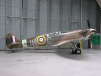 G-MKVB @ EGSU - Spitfire BM597 hangared at Duxford - by Simon Palmer
