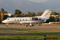 N247AD @ VNY - This Gulfstream G-II(SP) is crossing RWY 16R to go to the bizjet run-up area to conduct some tests on the engines, which are uncowled.