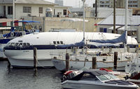 N19904 - The Cosmic Muffin seen docked in Ft. Lauderdale in May 1990. - by John Meneely