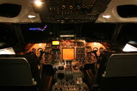 G-AWZK @ EGCC - Night shot of the flightdeck,note Concorde G-BOAC floodlit. - by Neil Lomax